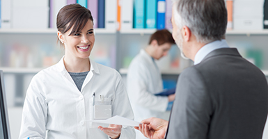 man-giving-prescription-to-female-pharmacist
